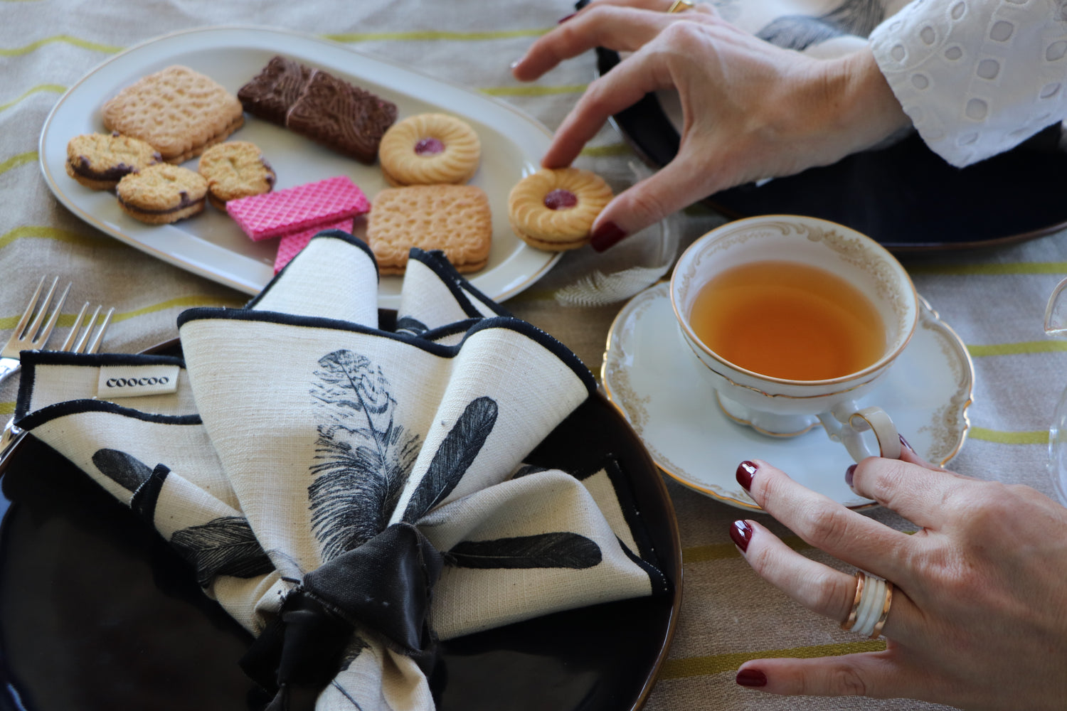 Tea cup with cookies on a table setting